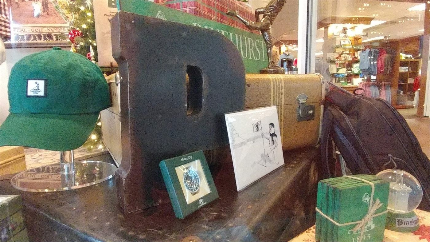 Cards and prints displayed on a table in a Pinehurst retail shop.